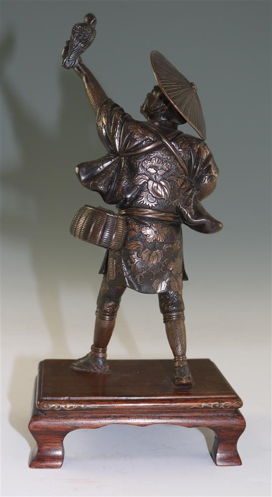 A Japanese two-colour bronze figure of a falconer, by Miyao, Meiji period, total height 26cm, lacking item to left hand